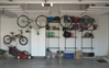 Garage with multiple organization items - cabinets, wall grid, overhead storage and wall shelving