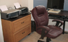 View of the left side of the desk  showing a secondary large lateral file cabinet that serve the duel purpose as the printer stand.