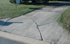 Original driveway showing surface deteriorating and cracks. Age of driveway over twenty years.