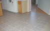 Installation of floor tiles with seamless threshold to wood and carpeting flooring.
