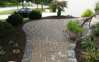 New walkway with circular design and outer trim using pavers.